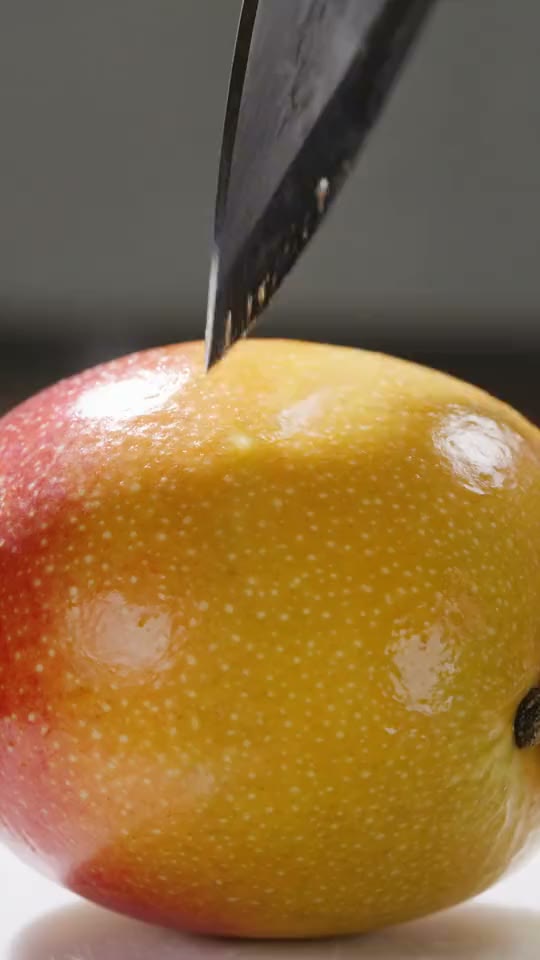 A ripe mango sliced open, close up