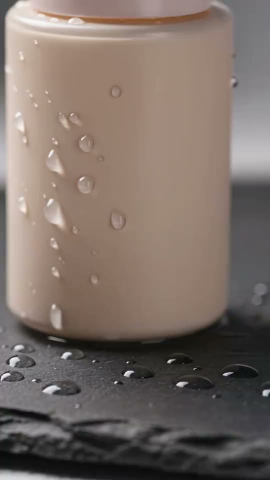 Water droplets on a skincare bottle, close up